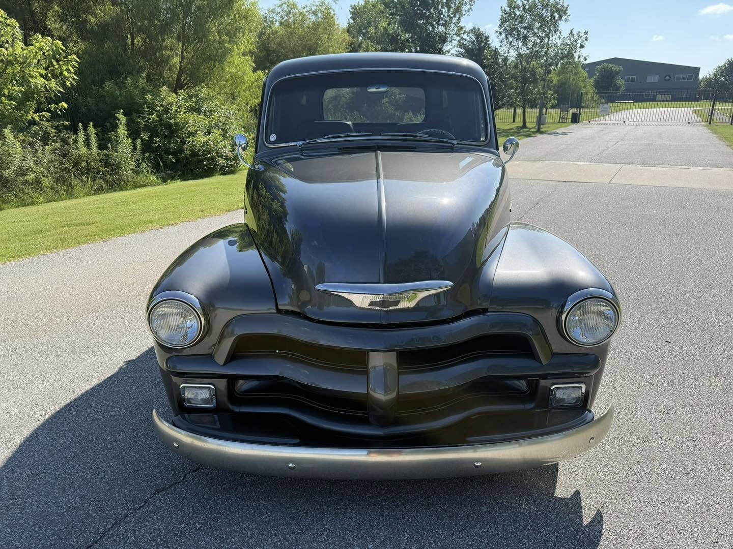 A classic black Chevrolet truck detailed at a show