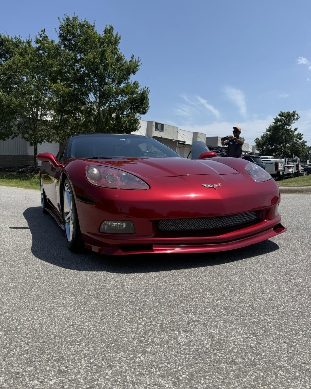 A red Chevrolet Corvette at a car show